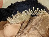 a crown on top of a bralet on a bed