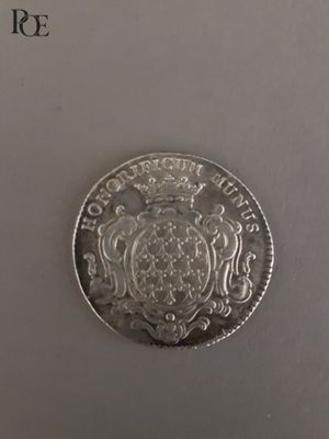 gros plan d'une pièce d'argent sur une surface blanche