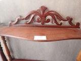 a wooden bench with a sign on the back of it