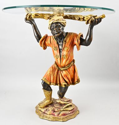 an image of a statue of a man holding a tray on his head