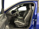 the interior of a blue car with two seats and a steering wheel