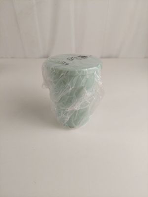 a roll of toilet paper wrapped in plastic on a white surface