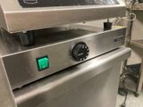 an image of a commercial fryer with a green button