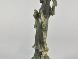 an image of a statue of a woman holding a bird on a rock