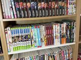 a book shelf full of dvds and dvds in a room