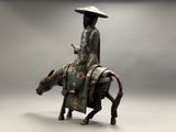 statue of a woman riding a horse with a hat on