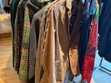 clothes are hanging on a rack in a clothing store