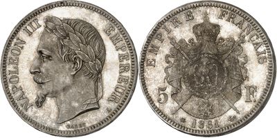 a silver coin with a woman ' s head and a crown on it