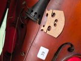 a close up of a violin that has a piece of wood on it