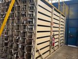 a large stack of metal pipes in a warehouse
