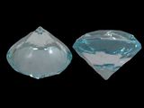 two pieces of clear glass sitting on top of a black surface