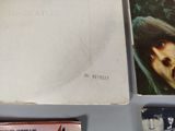an old book with a picture of the beatles on it next to some other books