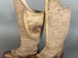 an old pair of brown cowboy boots sitting on top of a table