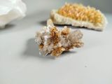 two pieces of crystal on a table with a piece of bread in the background