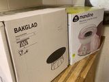 two boxes of bread sit on a wooden counter in a kitchen