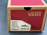 a box that has a pair of vans shoes in it