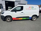 a white van that is parked in front of a building