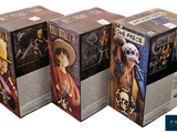 four boxes of one piece figurines in a row