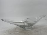 a glass bowl sitting on the ground on the ground