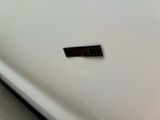 a sticker on the side of a white car