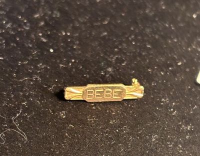 a small piece of gold on a black surface