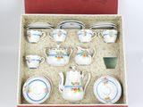 a box that has a set of tea cups and saucers in it
