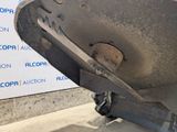 a close up of a car ' s bumper with a sign in the background