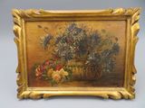 tableau représentant un vase de fleurs posé sur une table, dans un cadre doré