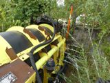 a yellow and black machine that is sitting in the grass