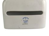 a white paper towel dispenser on a white surface