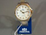 an image of a gold and white watch with a tag on it