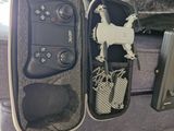a suitcase with a remote control and other items in it