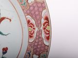 a close up of a plate with flowers and birds on it