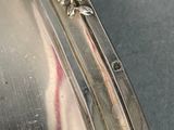 a close up of a silver plate with a bird on it