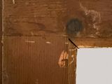 a picture of a hole in a wall with a piece of wood sticking out of it