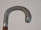 a close up of a metal and wood walking stick