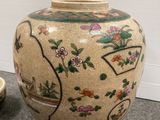a vase and a bowl sitting on the floor