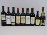 several bottles of wine are lined up in a row on a white surface