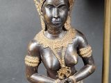 a statue of a woman holding a flower in her hands