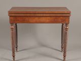 a small wooden table with turned legs and a wooden top
