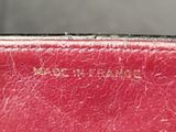 a close up of a red purse with writing on it