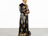 an image of a statue of a man in a black and gold robe