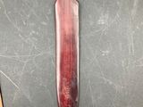 a knife that is laying on a table next to a pair of scissors