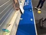 a long blue carpet on the ground next to a window