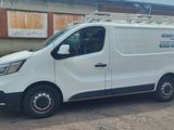 a white van parked in front of a building