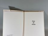 an open book sitting on top of a table next to a wall