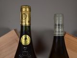 two bottles of wine sitting next to each other on a table