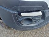 a close up of the front bumper of a white truck