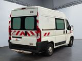 a white van with red stripes parked in a room
