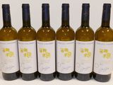 six bottles of wine are lined up on a table